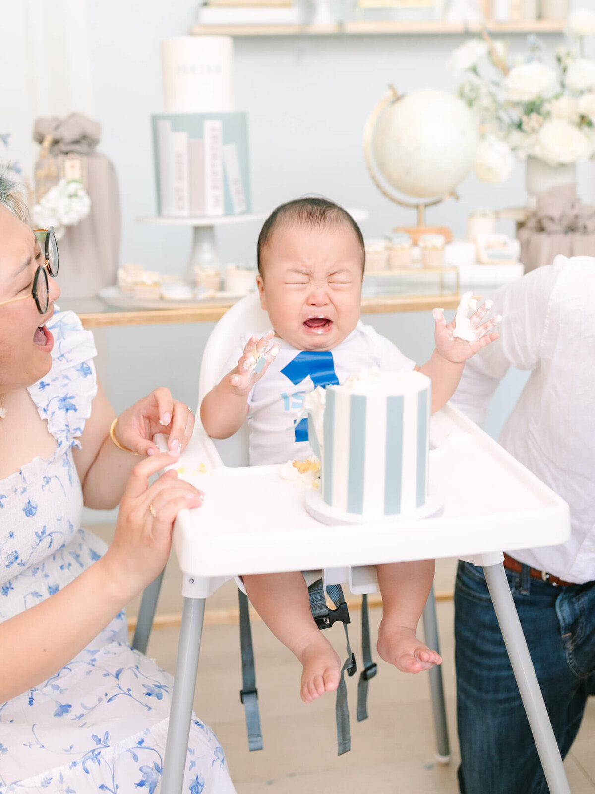 baby crying during first birthday smash cake photoshoot