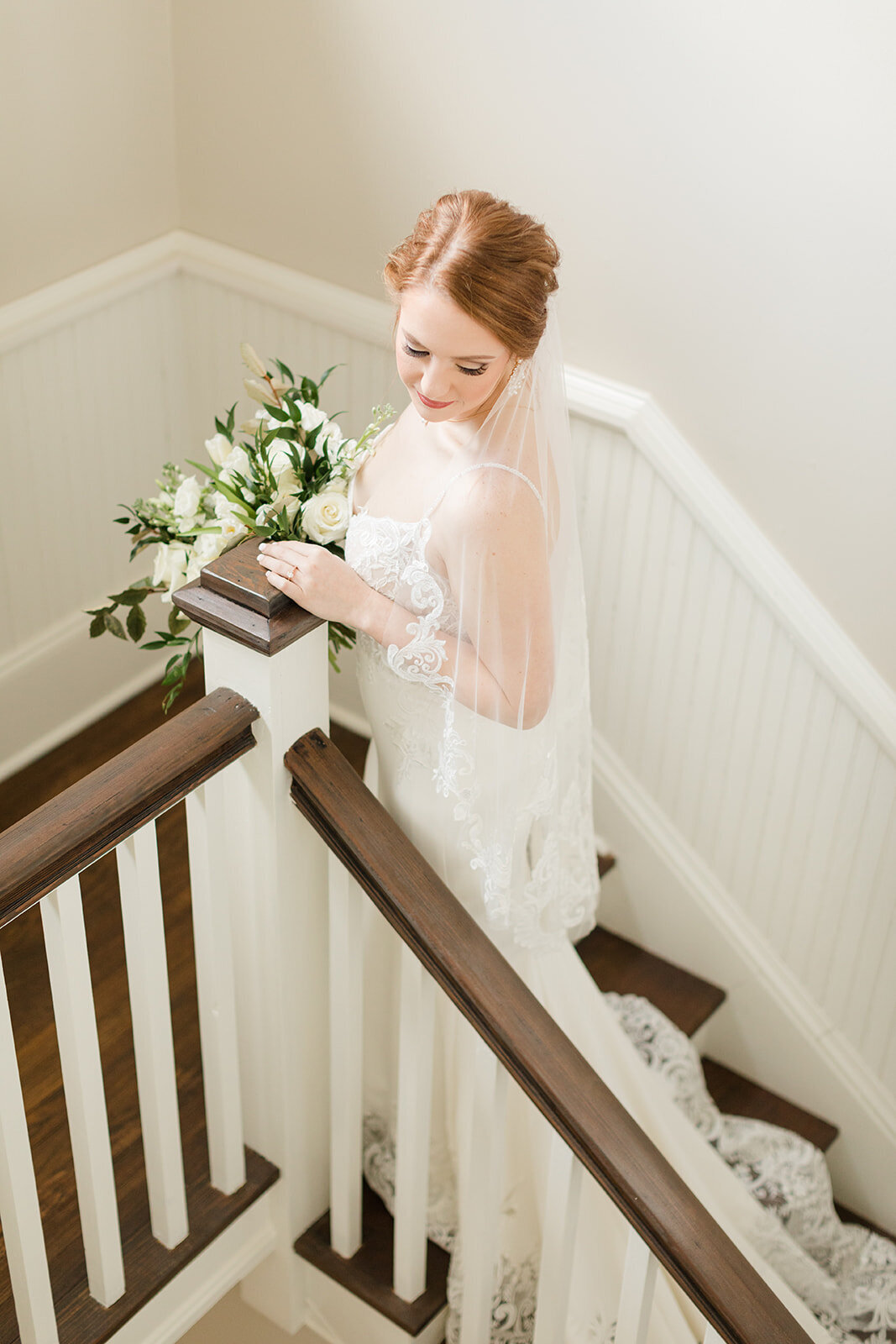 Bride ascending stairs at Venue de LaChute; Shreveport, Louisiana