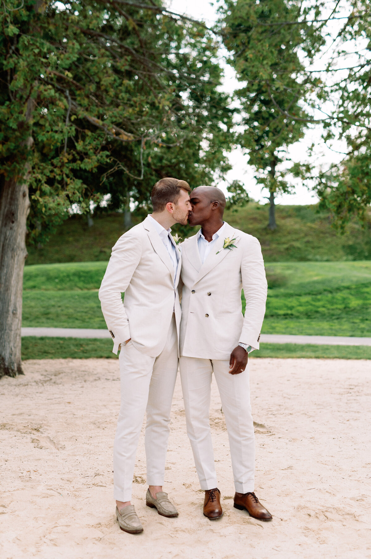 Gay couple kissing on the beach Toronto wedding interracial
