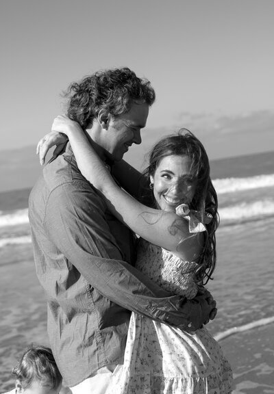 Florida engagement photography of couple hugging each other at the beach taken by Shelby Ann Photos