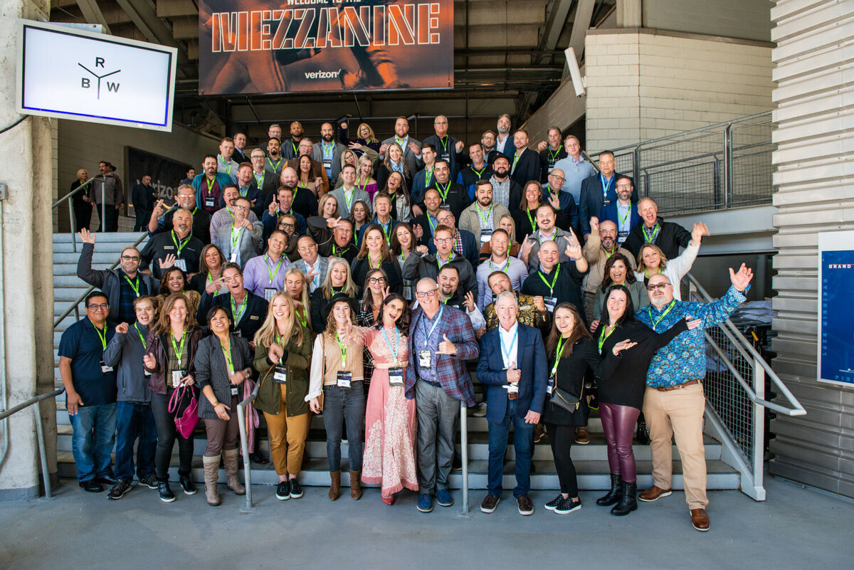 Group photo of event attendees wearing name badges and lanyards