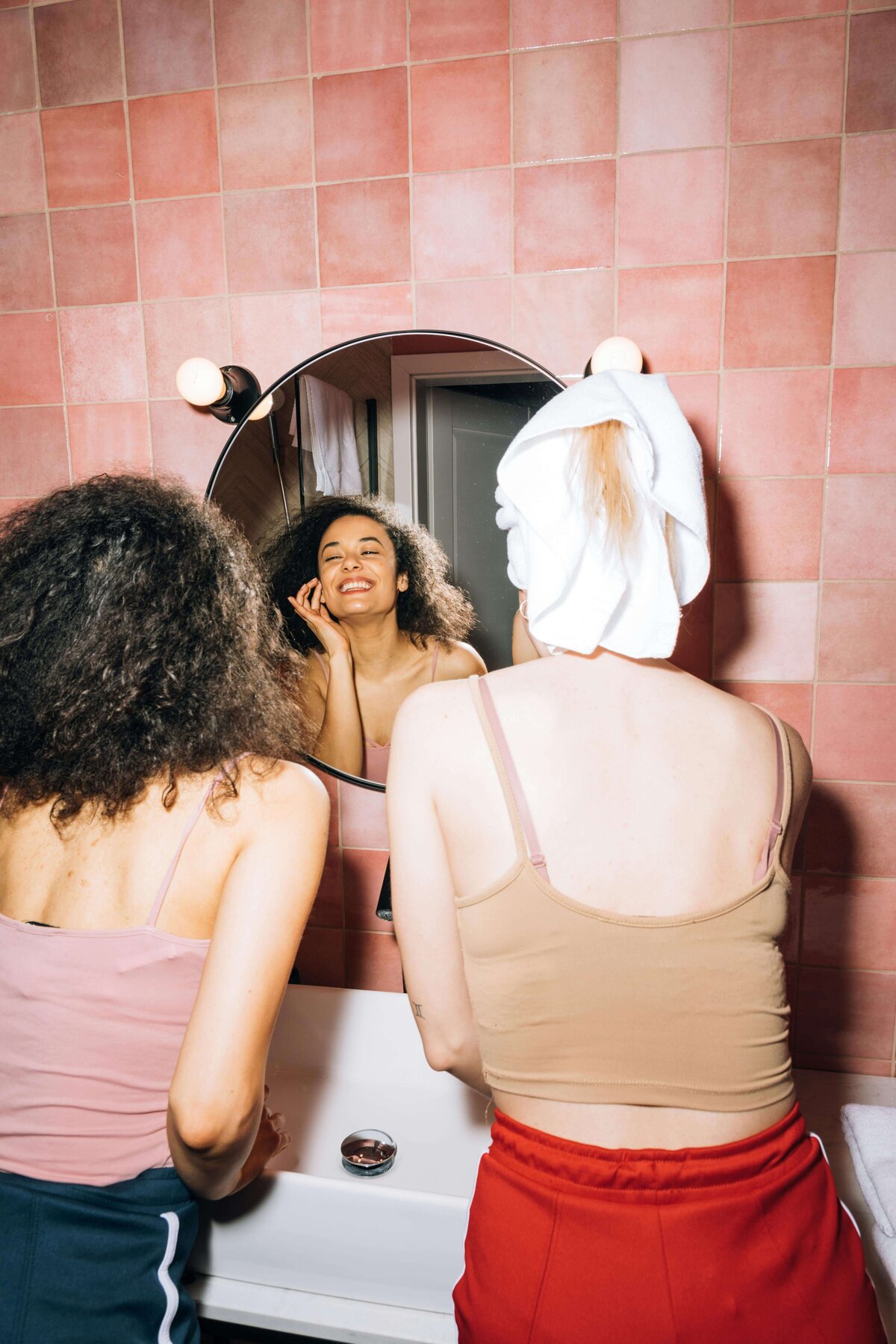 females in bathroom doing their plastic-free skincare routine