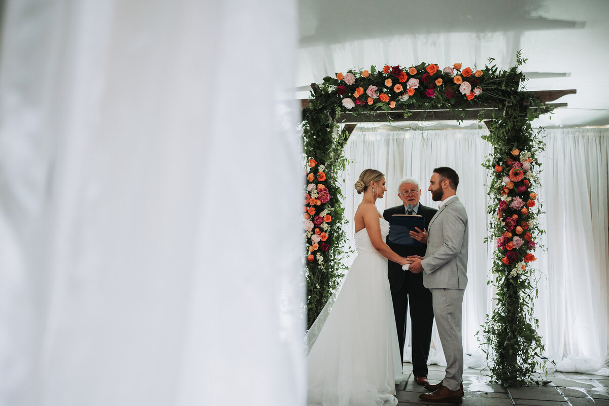 Couple looking intimately at each other at the alter just before they're married.