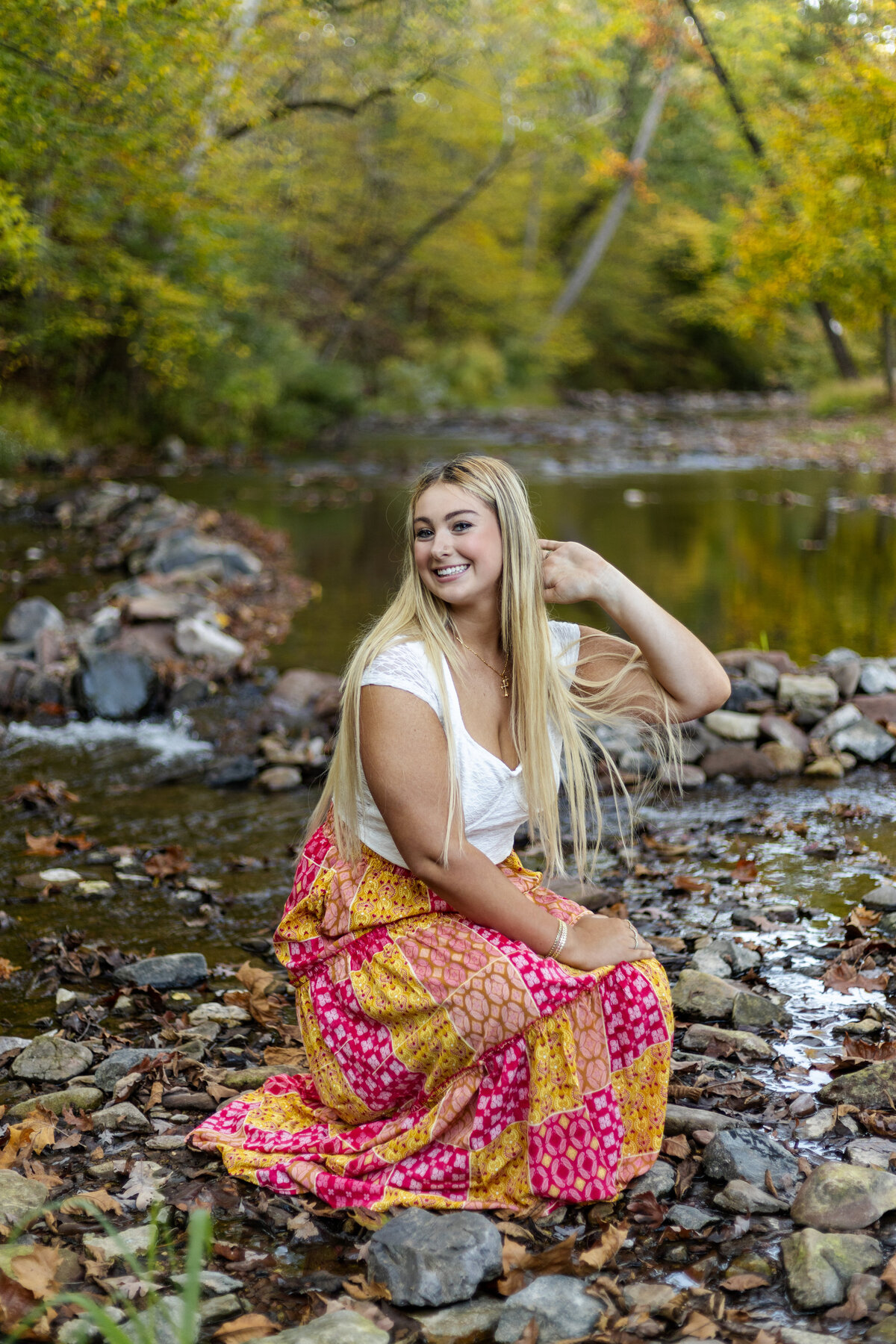 senior girl posing in an open field at golden hour in berks county pa