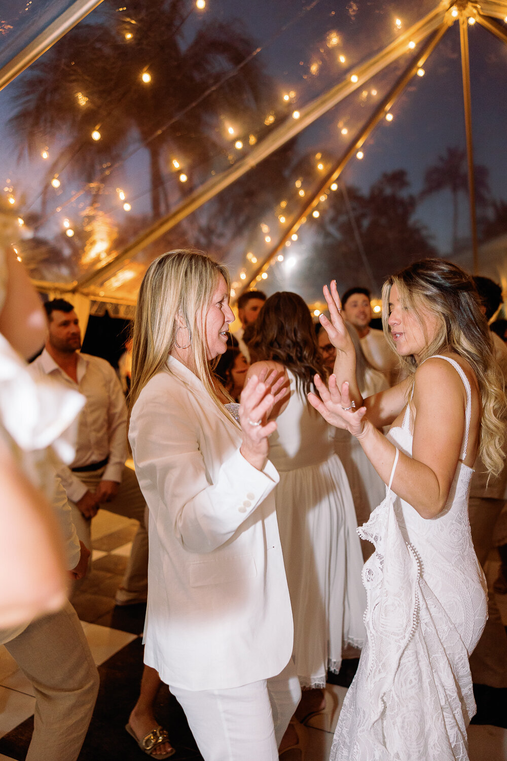 Bride Laura dancing with her bridesmaids at the lively wedding reception at Cheeca Lodge Resort.