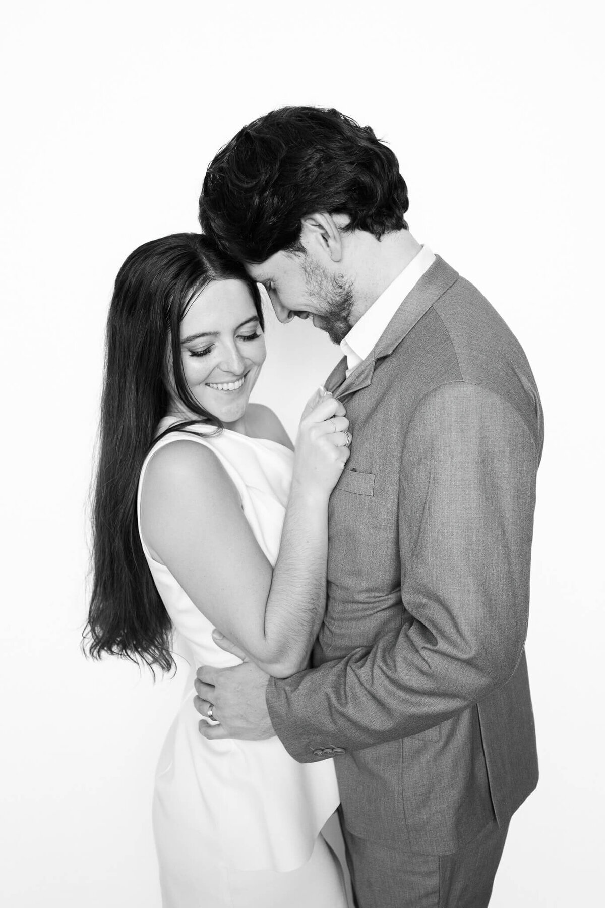 A tender moment between a couple as they lean in close, captured in a timeless black and white portrait by Monochrome Portraits, an elevated Phoenix photo booth experience.