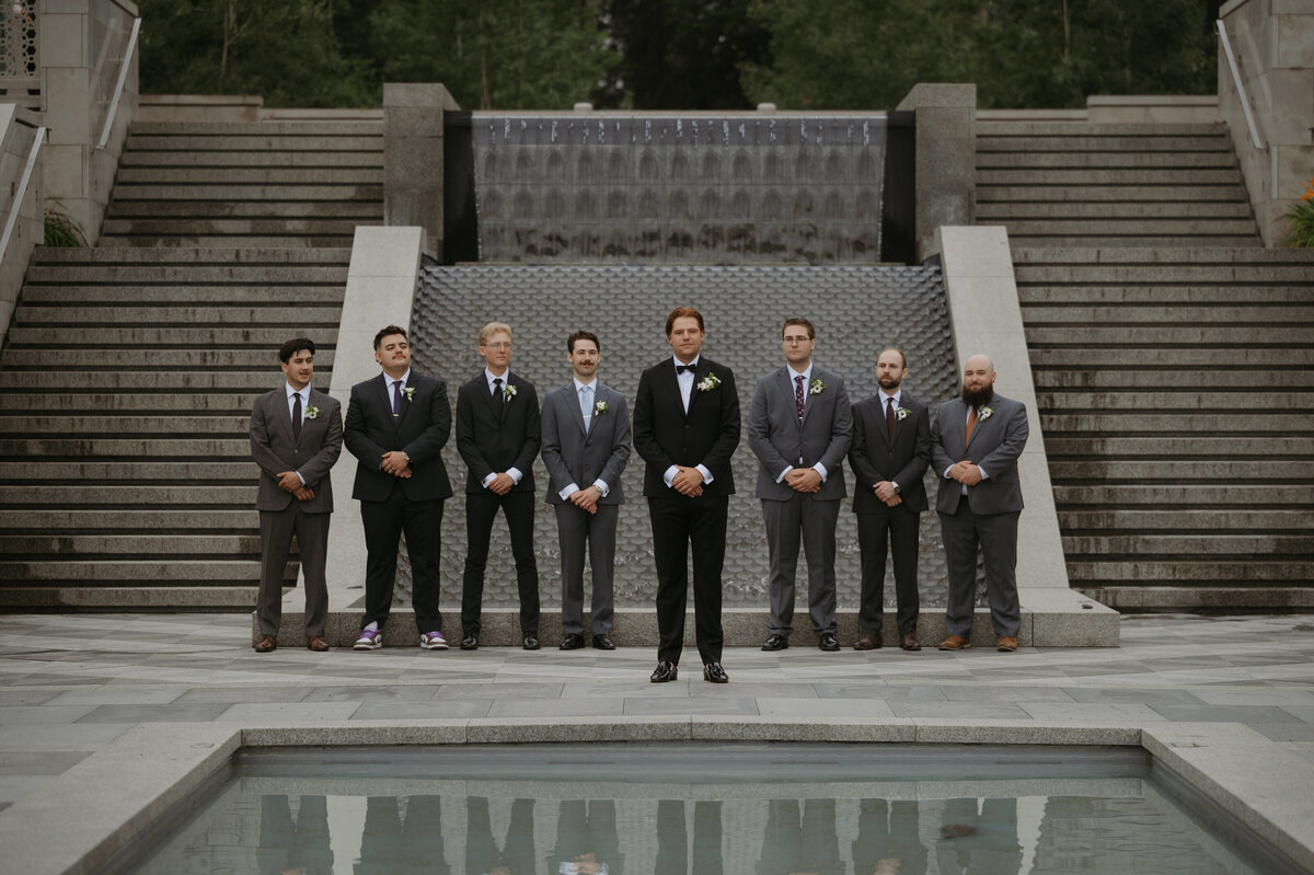 groom and groomsmen atandig at U of A botanical gardens 