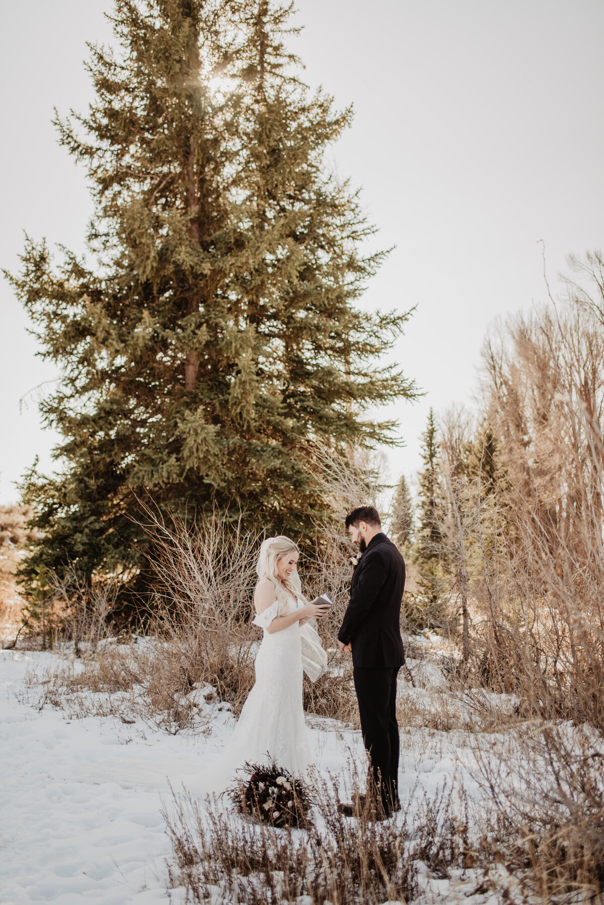 Jackson Hole Photographers capture bride reading vows during winter elopement