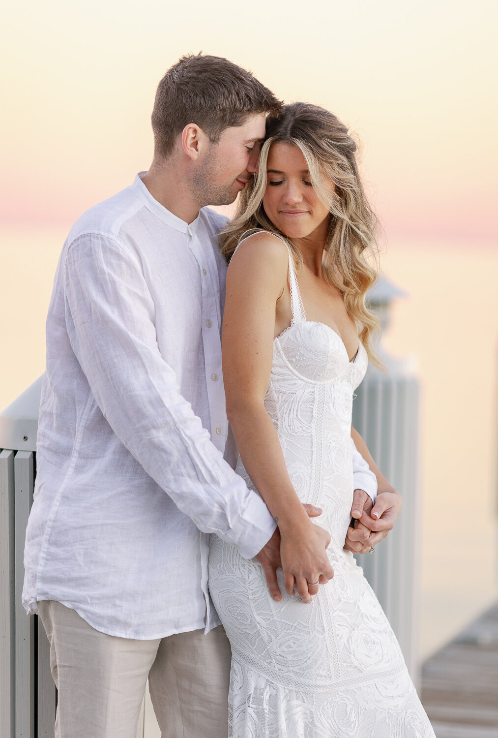 Bride Laura and groom Abraham sharing a romantic moment on the dock at sunset at Cheeca Lodge Resort.