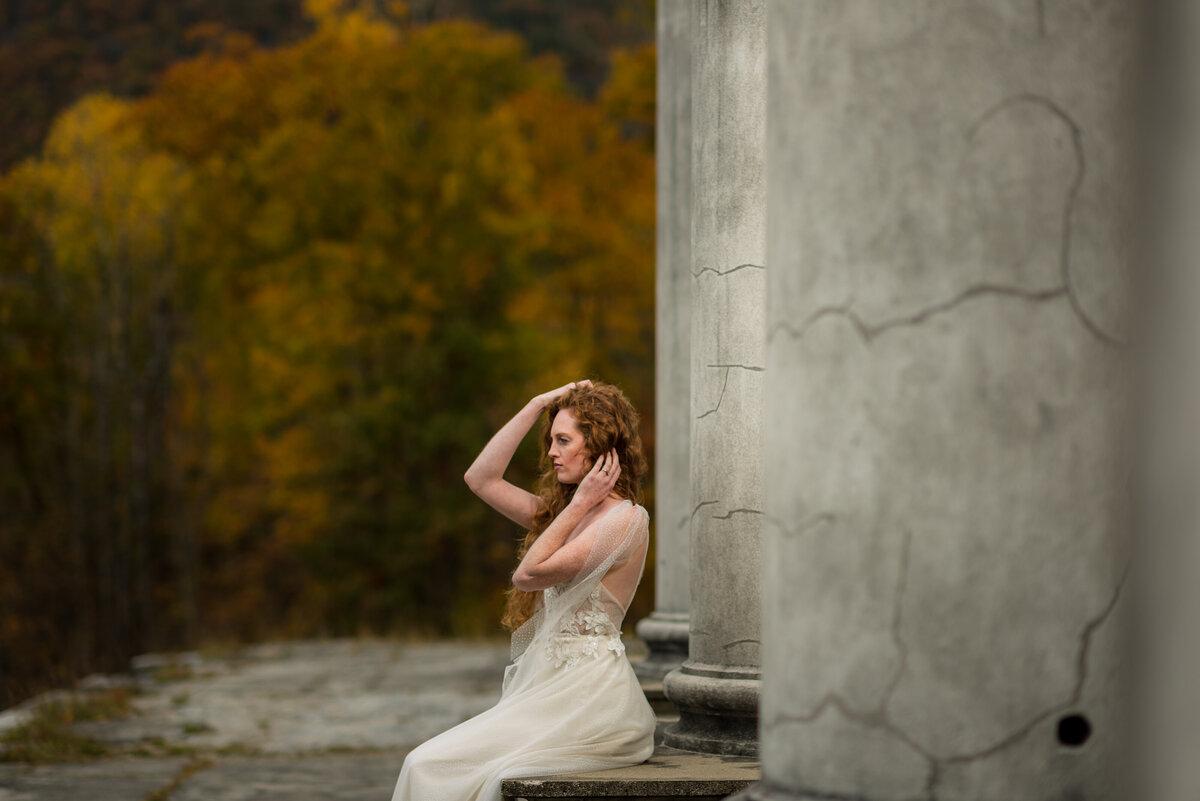 bride posing on her wedding day in her gown, hair and makeup