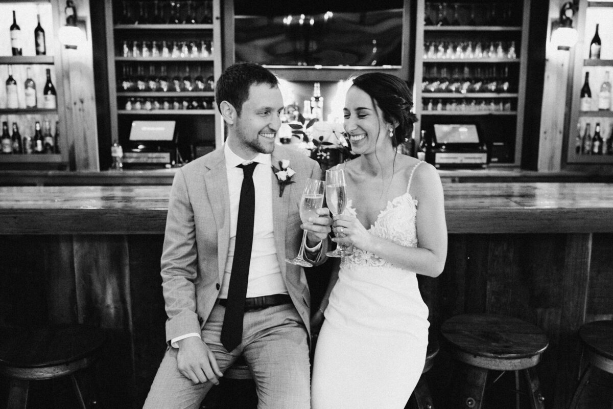 bride and groom drinking champagne