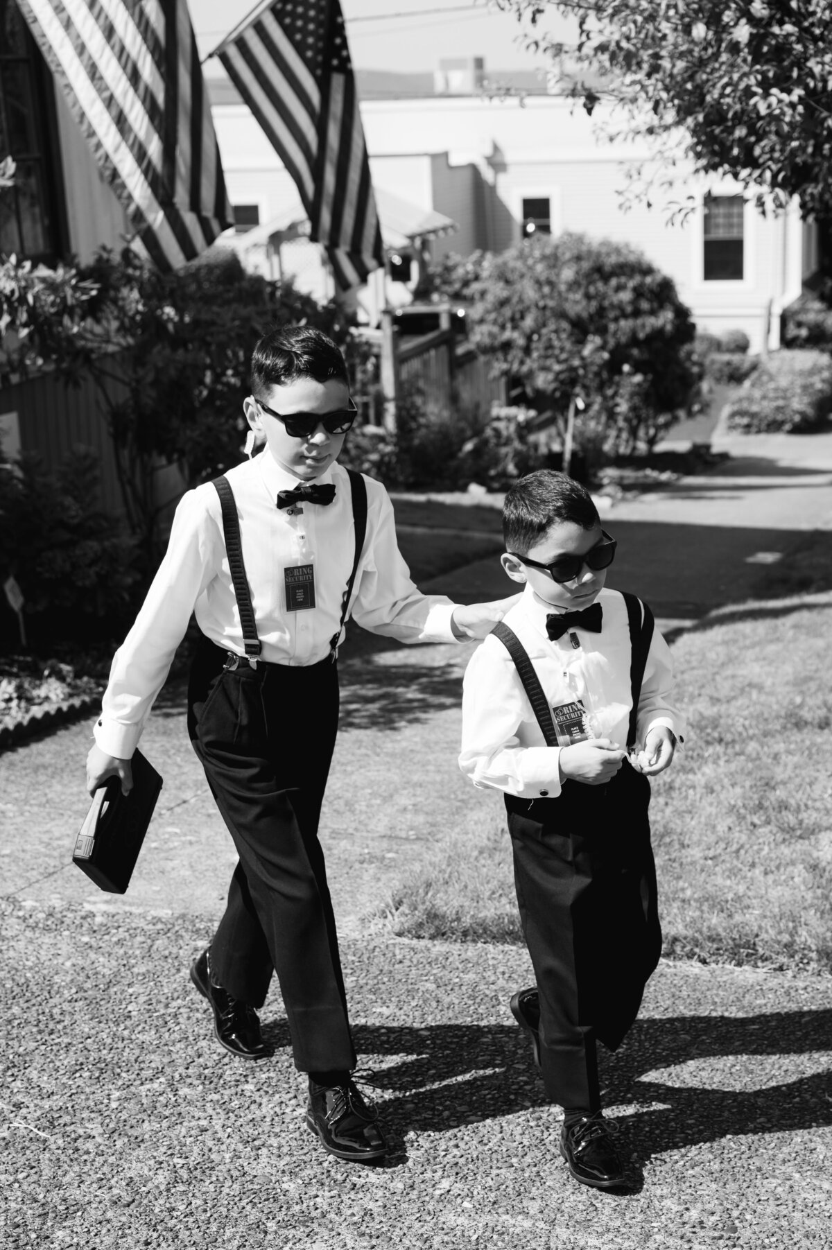 ring bearers walking to church in black and white