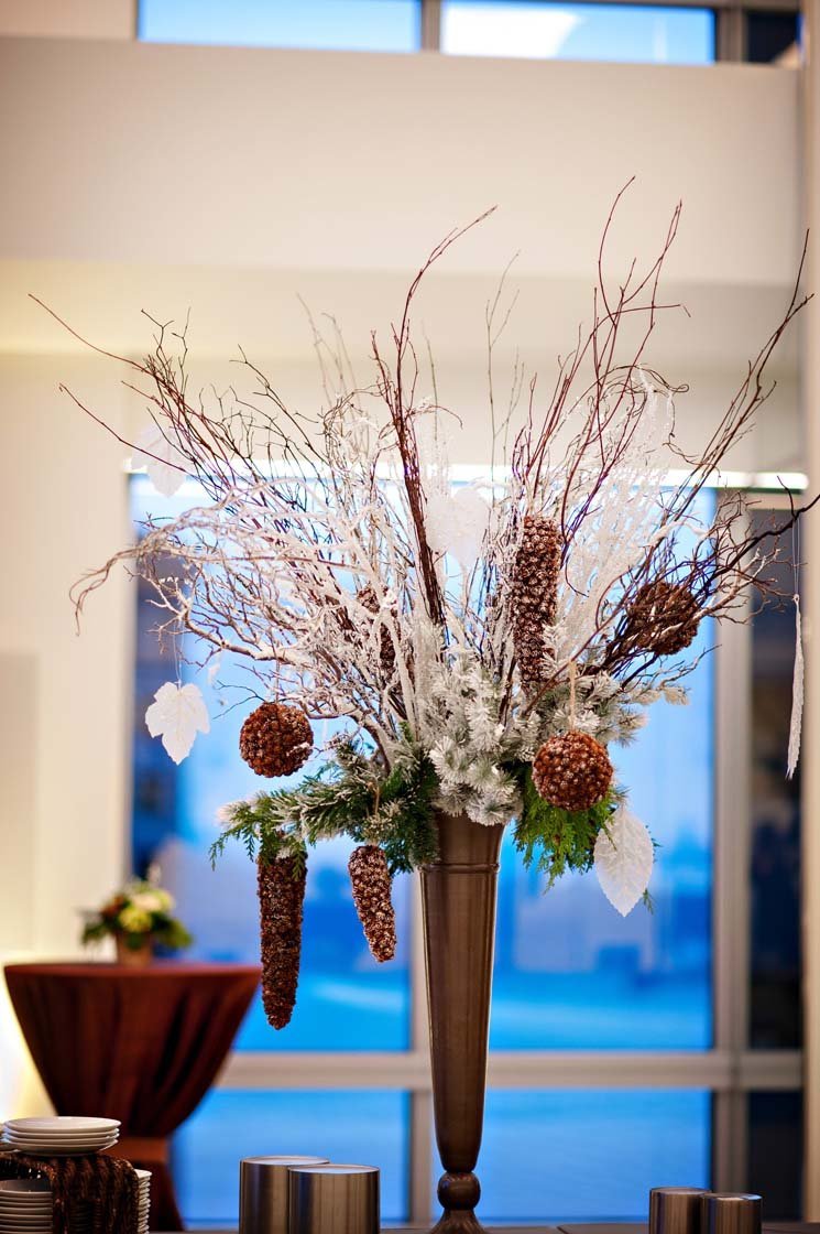 large food buffet centerpiece for holiday party with large cones, flocked branches, evergreens