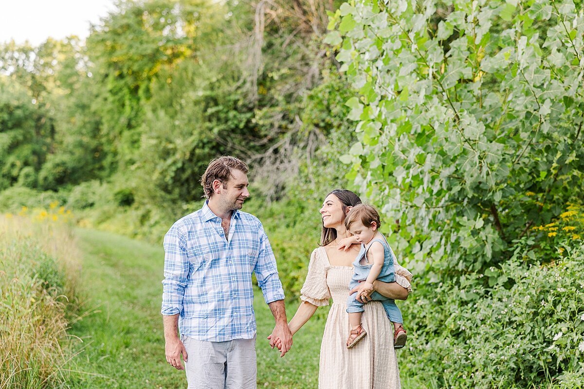 family walks together during Family photo session with Sara Sniderman Photography at Heard Farm in Wayland Massachusetts