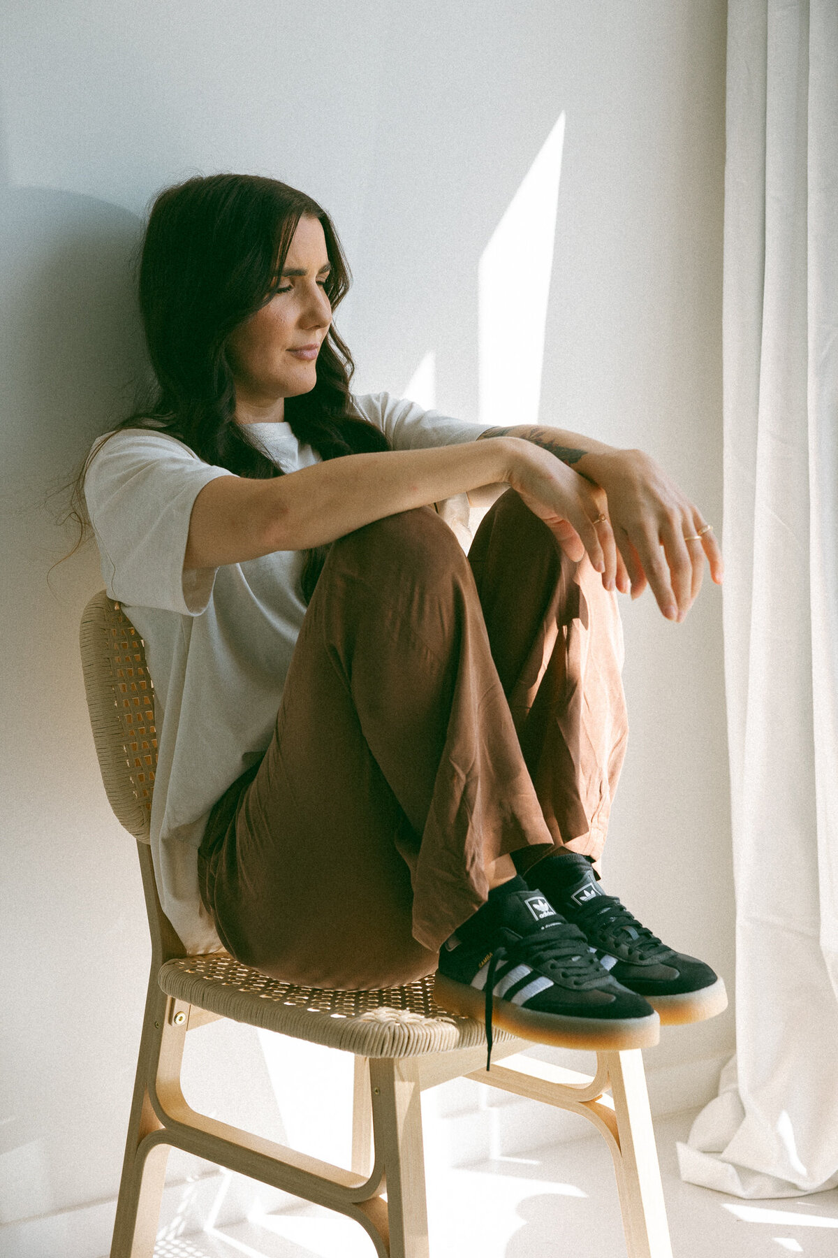 grunge dressed lady siiting on chair with knees up