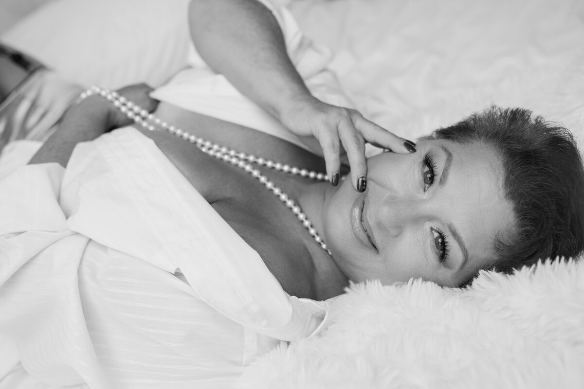 beautiful woman with short hair and pearls