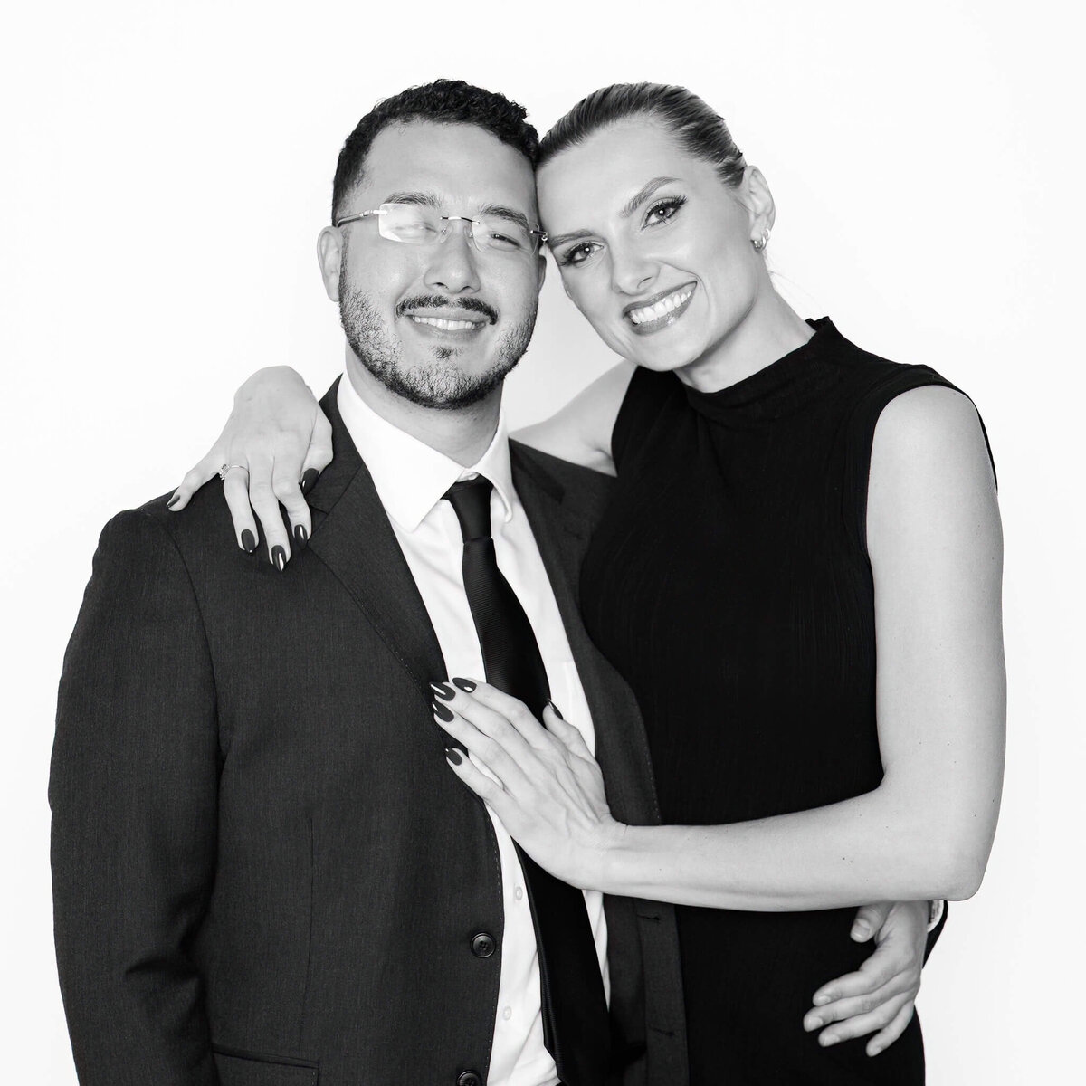 Elegant black and white portrait of a smiling couple captured by Monochrome Portraits, offering modern photo booth rentals for Phoenix weddings and upscale events.
