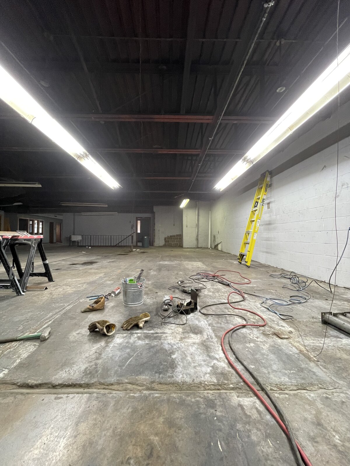 Commercial interior space prepared for welding and steel installation during a structural renovation project