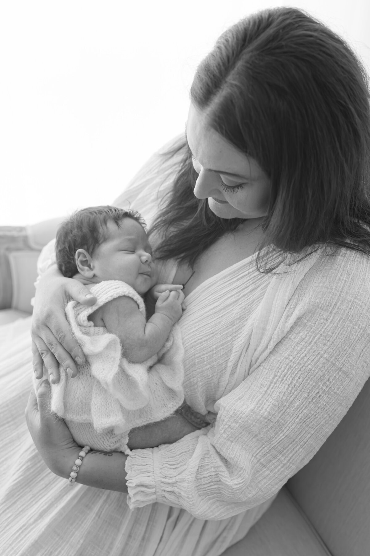 Mom cuddling baby during natural light Barrie newborn photography session 