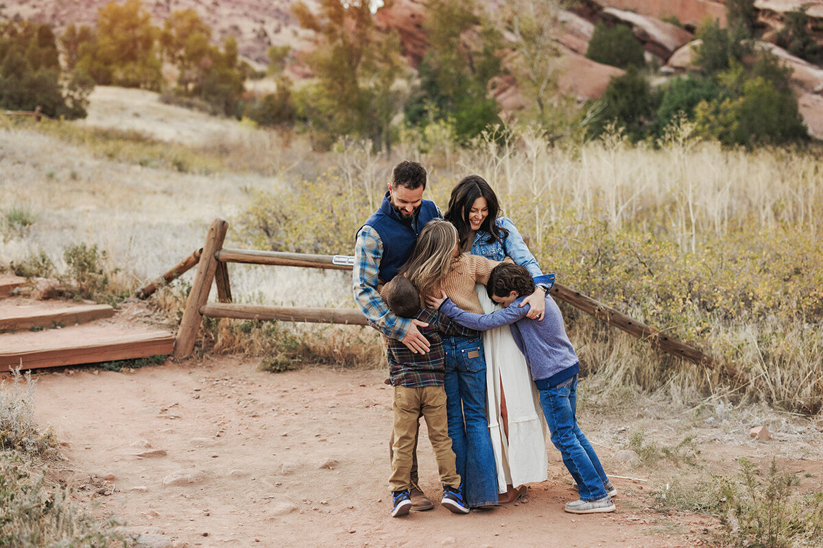 Red Rocks photo session with family hugging on the trail