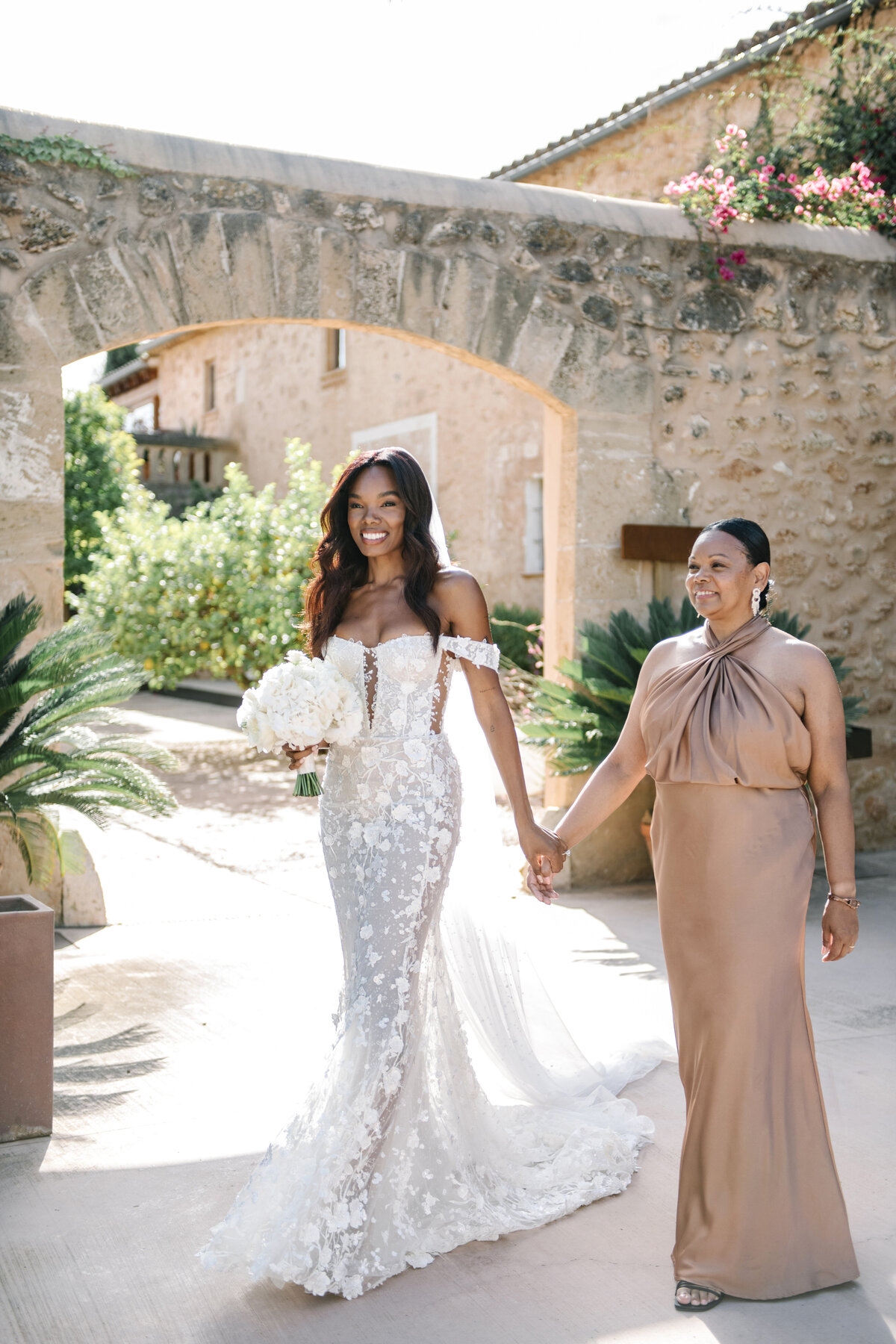 bride walking down aisle with mom at son mir wedding in mallorca