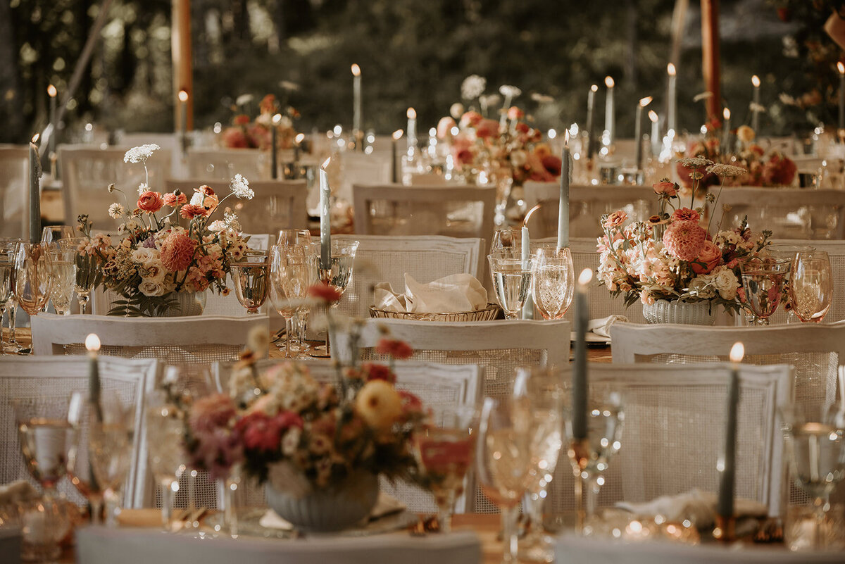 An outdoor wedding near Montreal with modern chic decor of candles and pastel garden flowers.