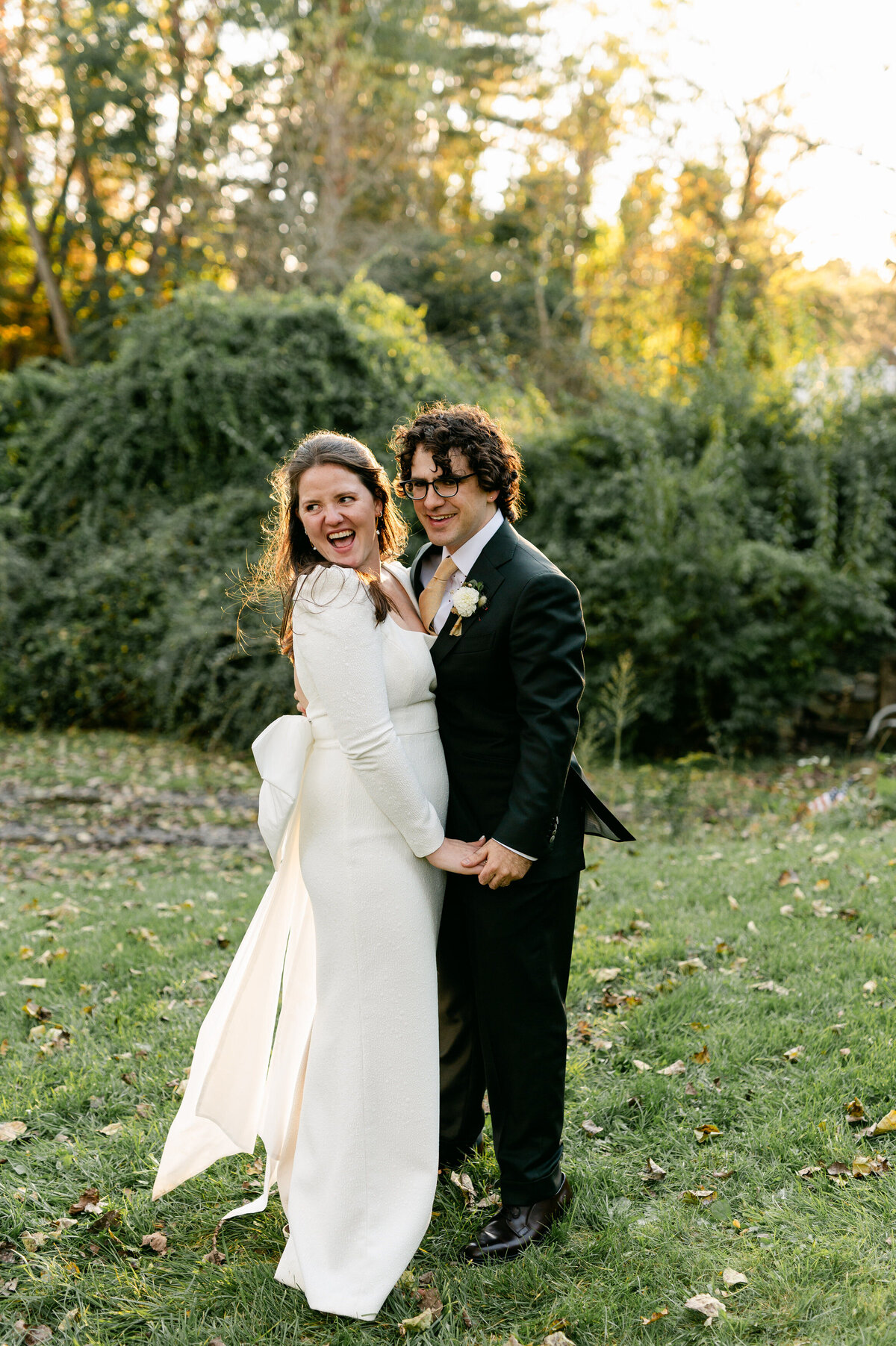 Bride and groom hand in hand smiling