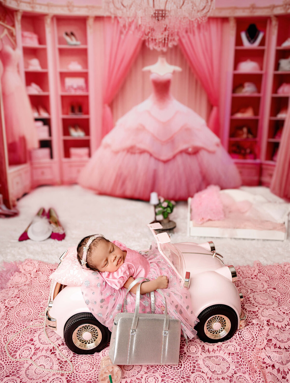 Barbie themed newborn  Toronto  photographer studio session with newborn girl posed in a car.