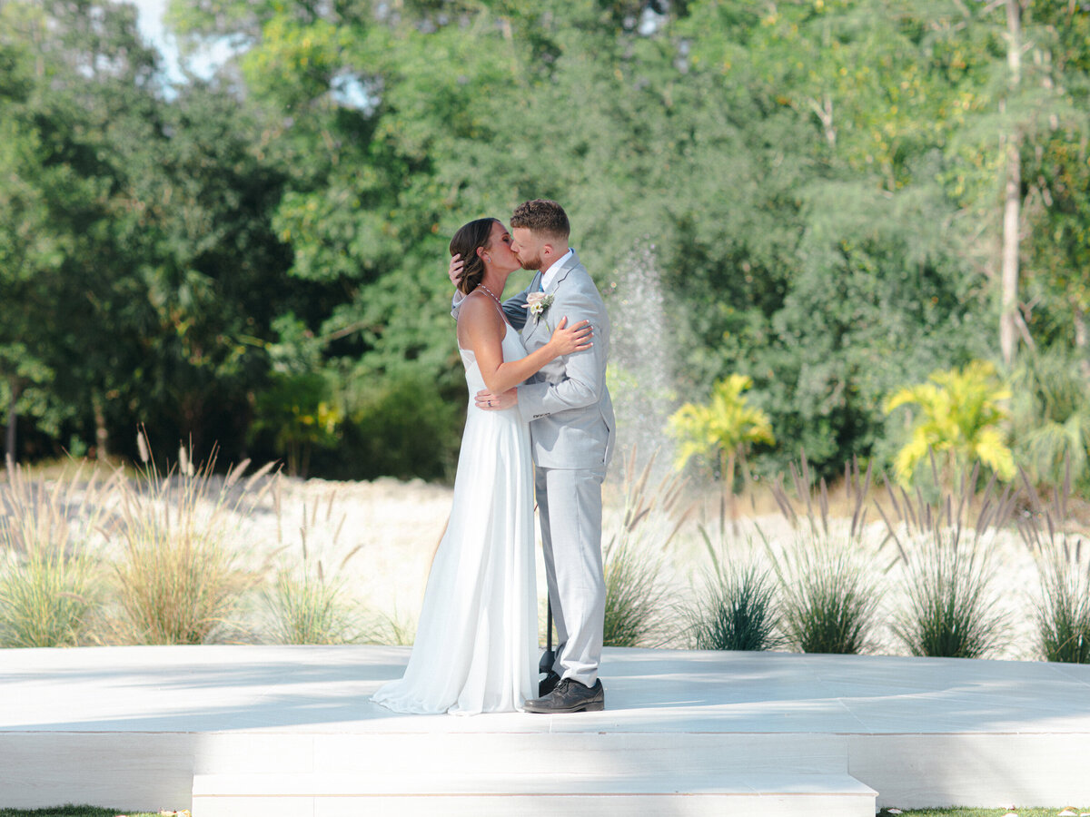 This image is of a bride and groom having their first kiss.