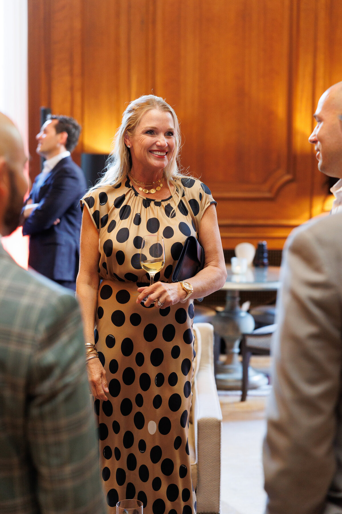 female smiling wearing a polka dots dress