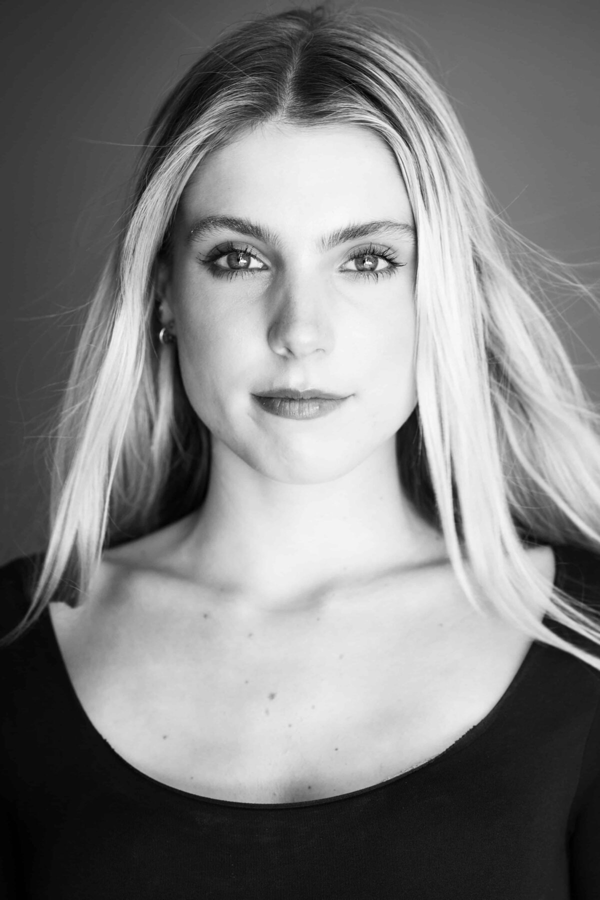 Black and white Close up headshot of a beautiful young woman with long hair