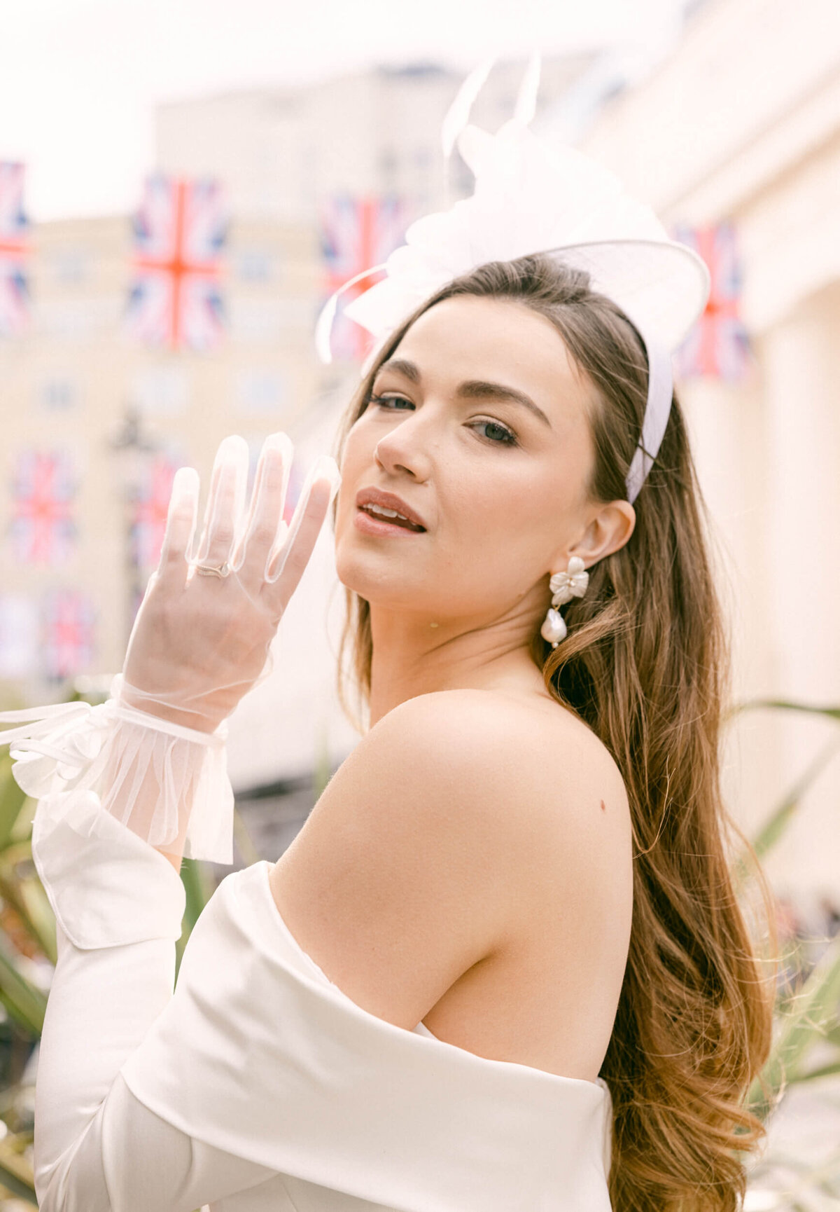 A wedding photo of the bride in her white wedding dress holding her white bouquet of flowers in London