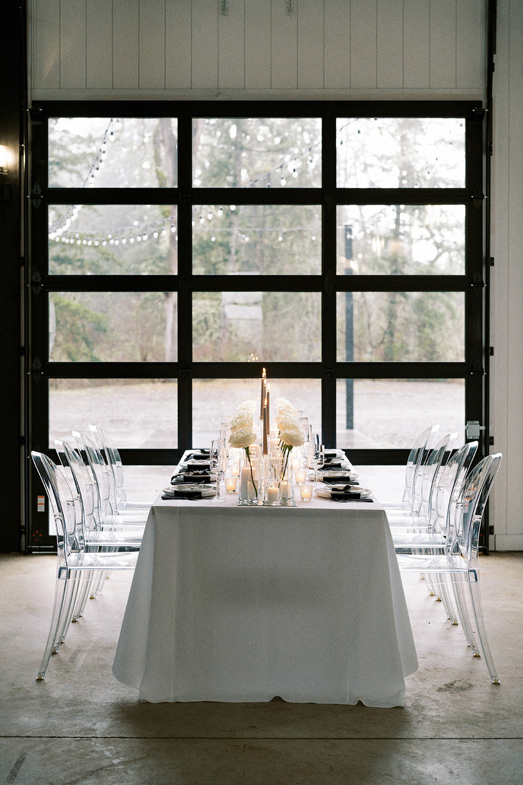 A table set for a wedding in front of a glass door at Sage and Social venue in Mulino Oregon.