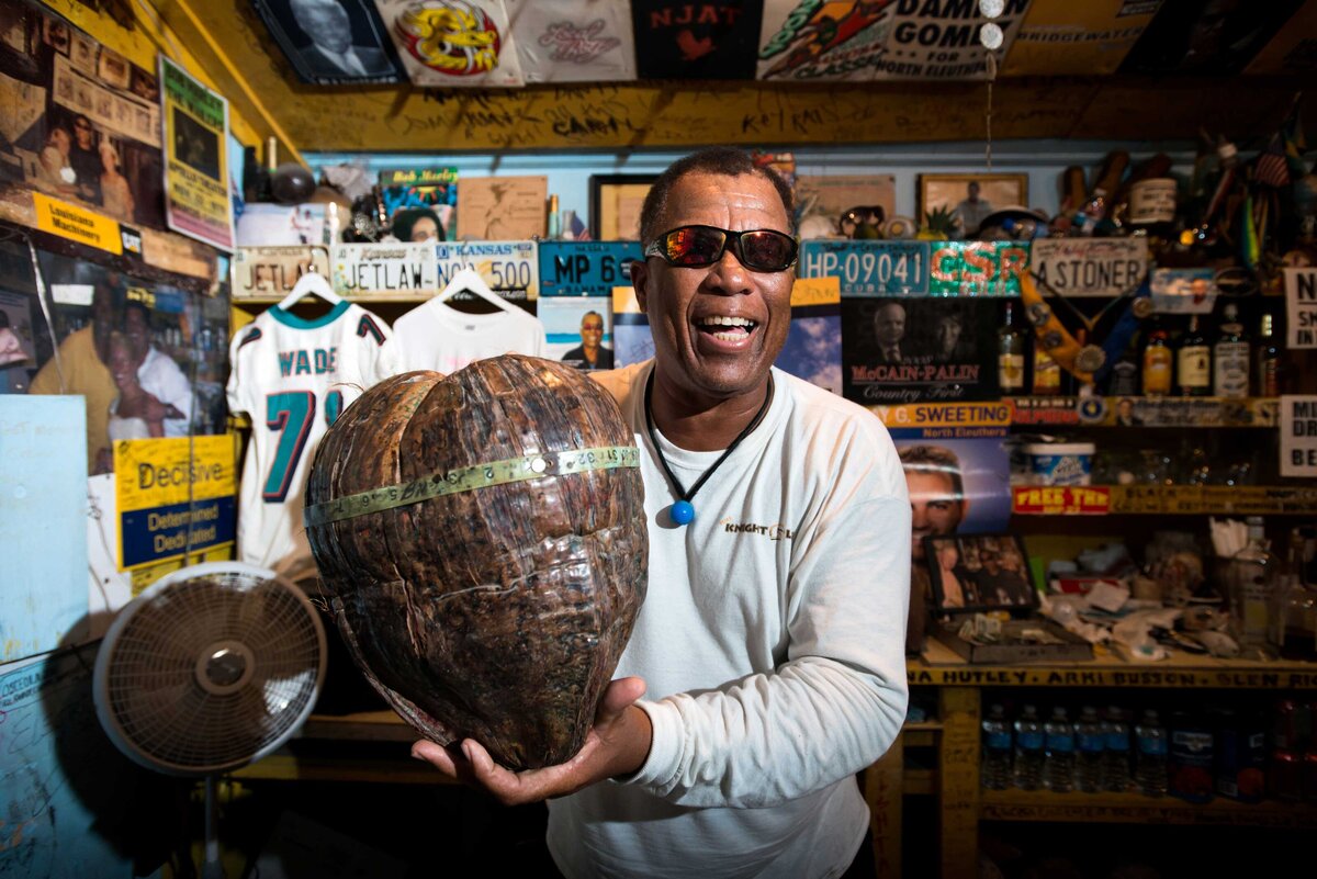Caribbean Tourism - The Vichum owner shows off the worlds largest coconut