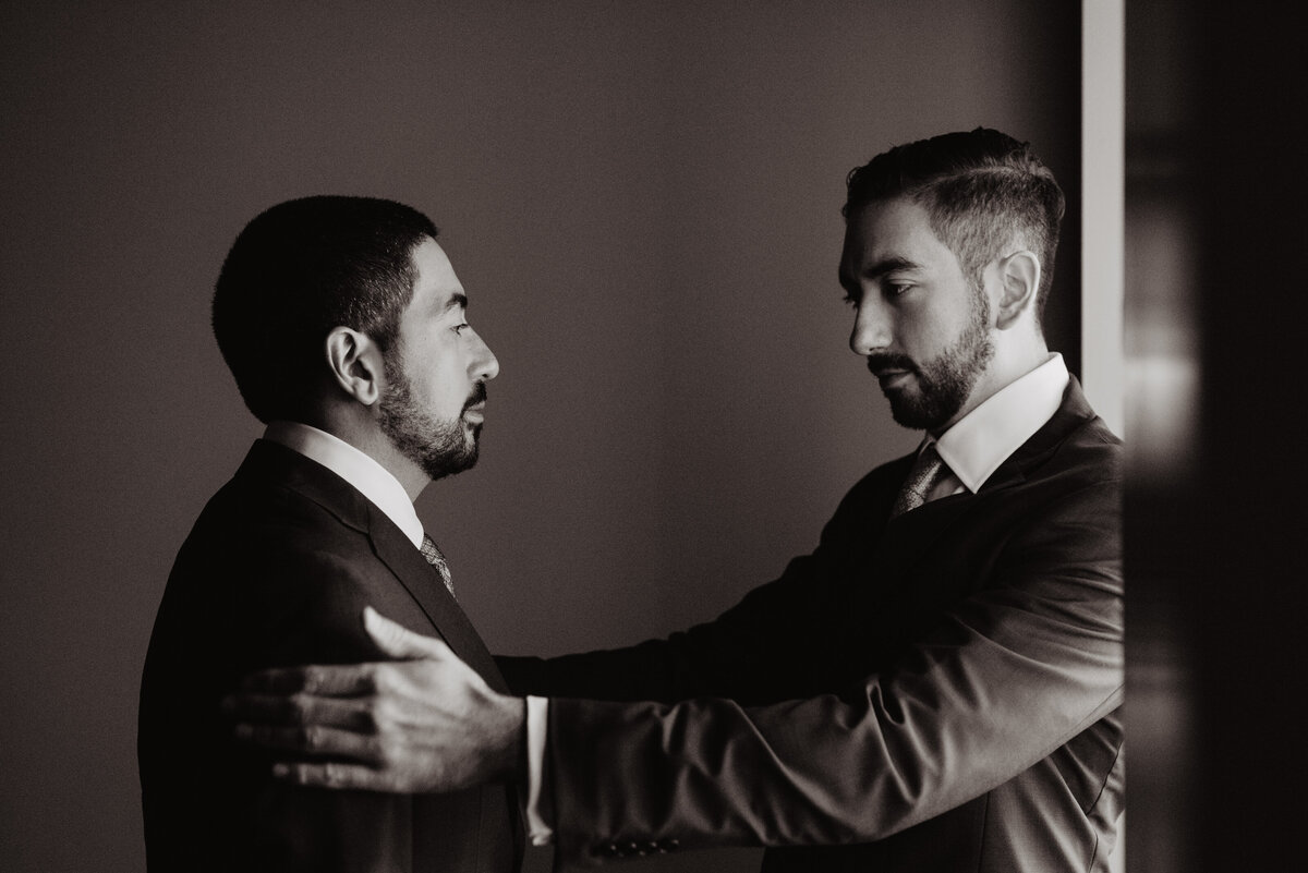 Photographers Jackson Hole capture groomsmen talking to groom