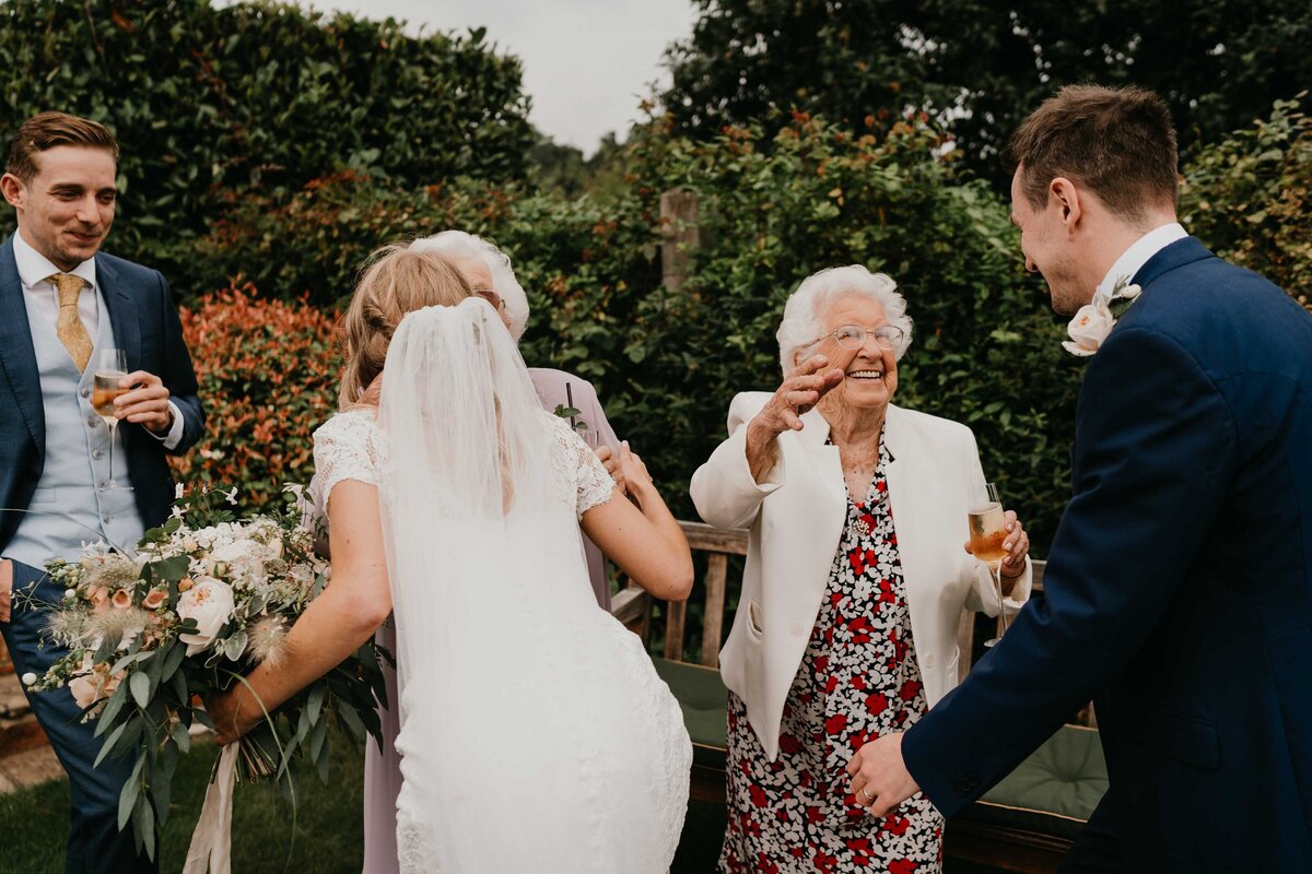 Bride & groom greeting Grannies at garden wedding in Hampshire-1