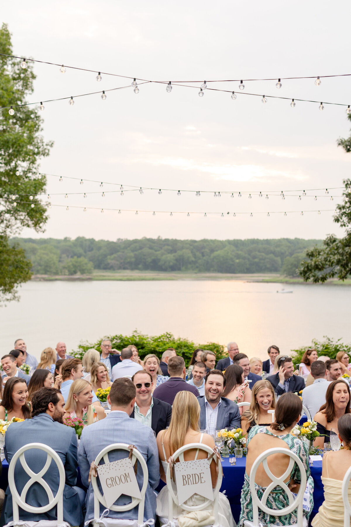Guests seated at long tables on the lawn of the Wainwright House for rehearsal dinner