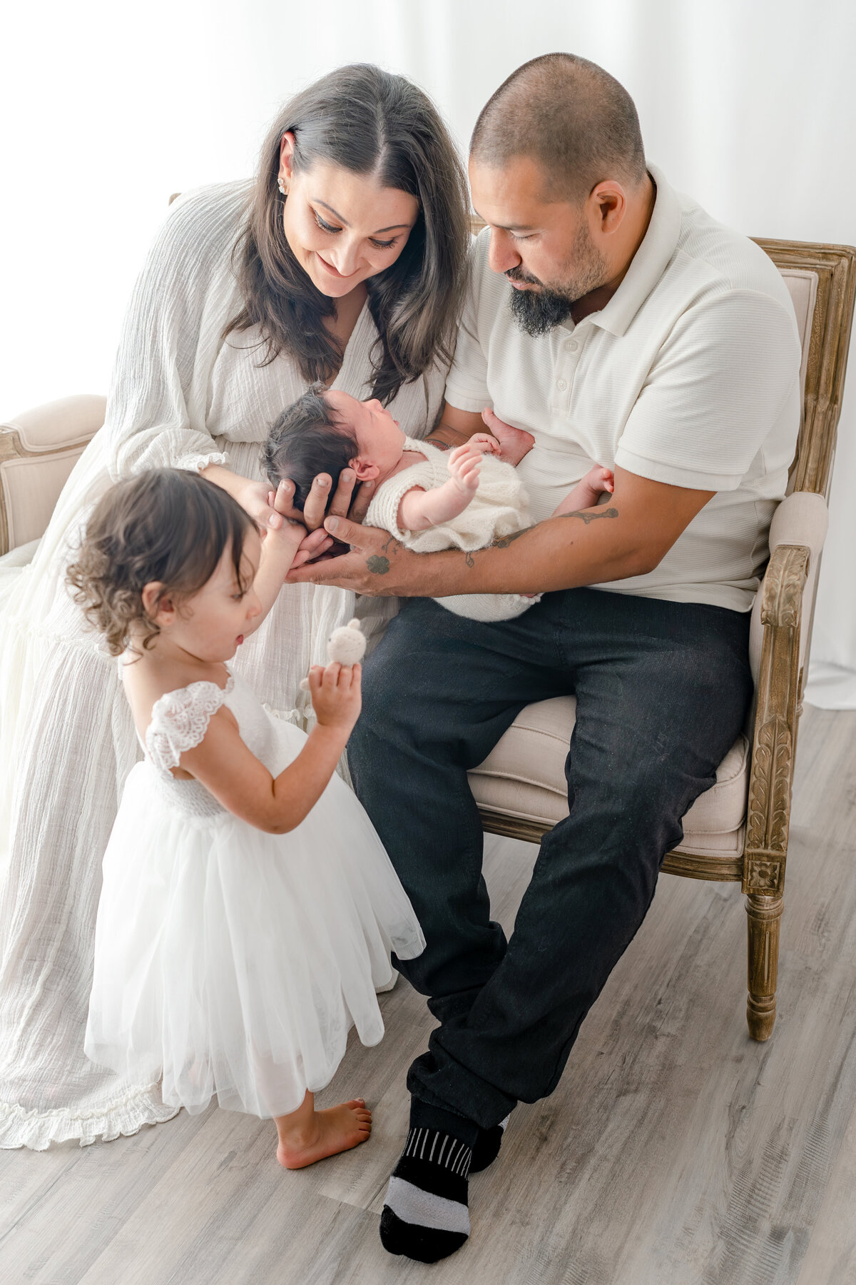 Family holding baby during natural light Barrie newborn photography session 