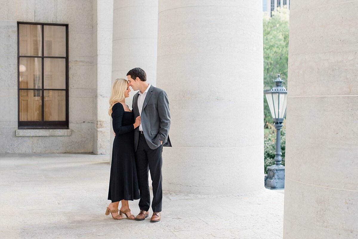 Couple by Ohio State House columns posed by the best Ohio Wedding Photorapher