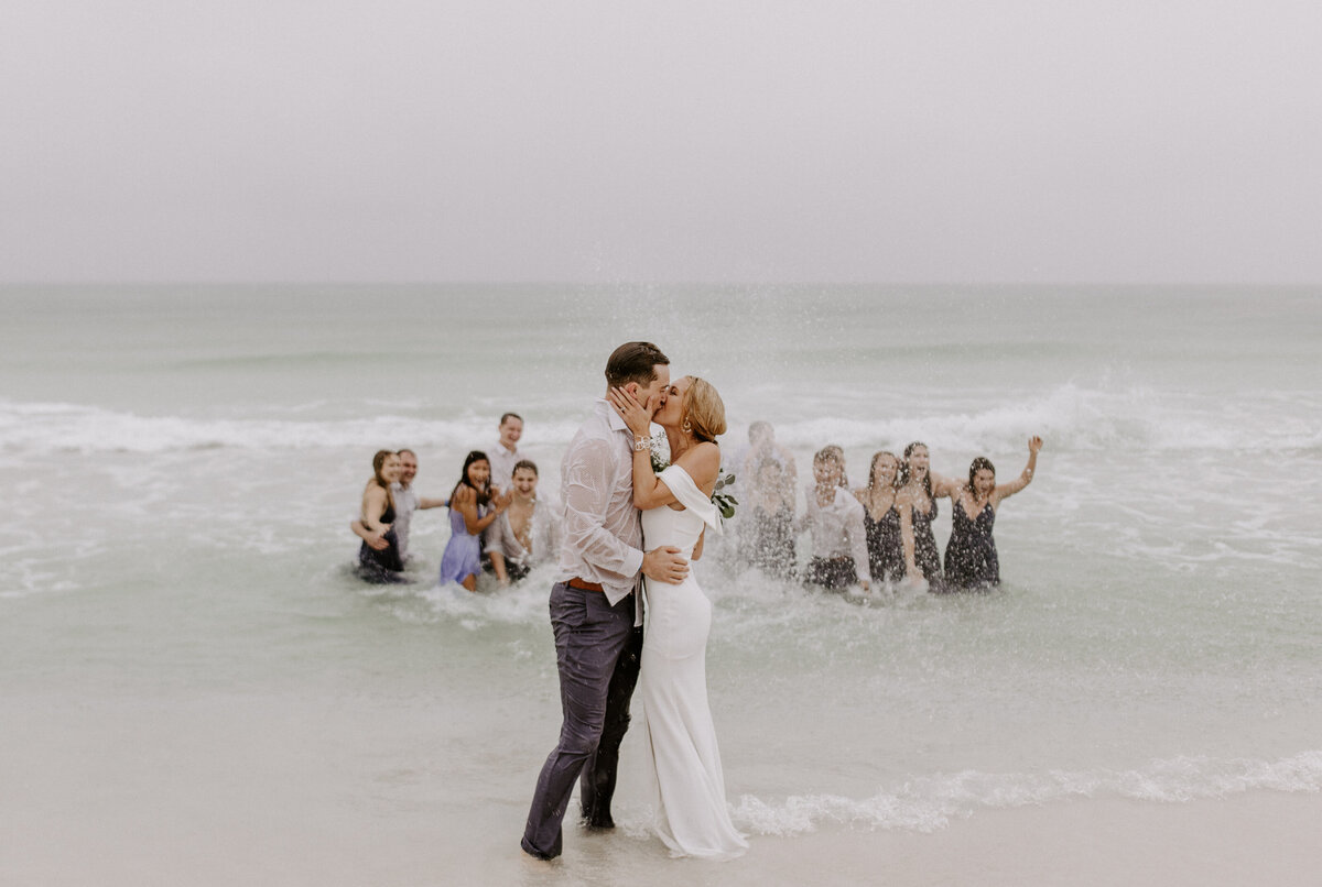 newlyweds walk on beach