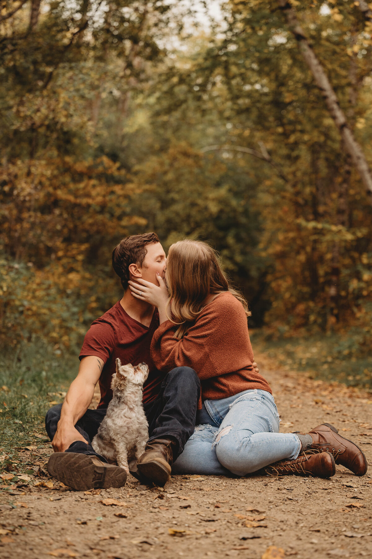 Edmonton couple and their dog in fall leaves