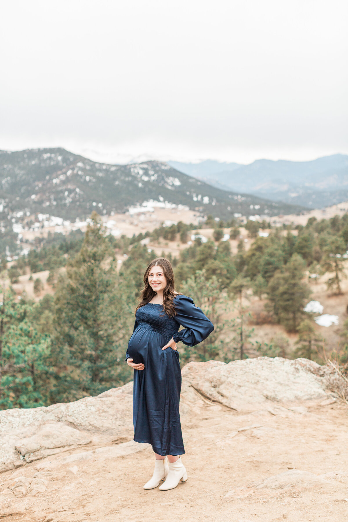A pregnant mother overlooking the mountains during her maternity session in Denver