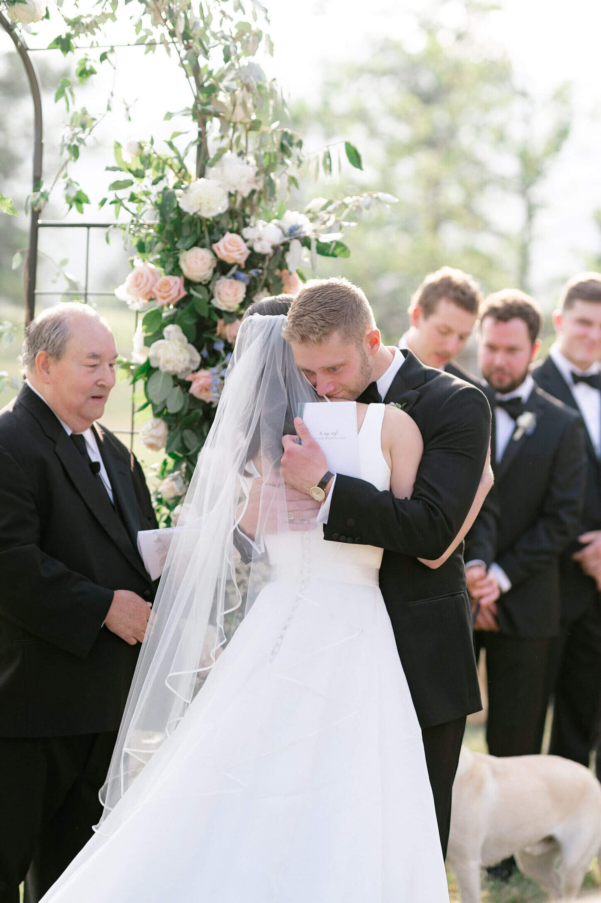 Groom hugging bride