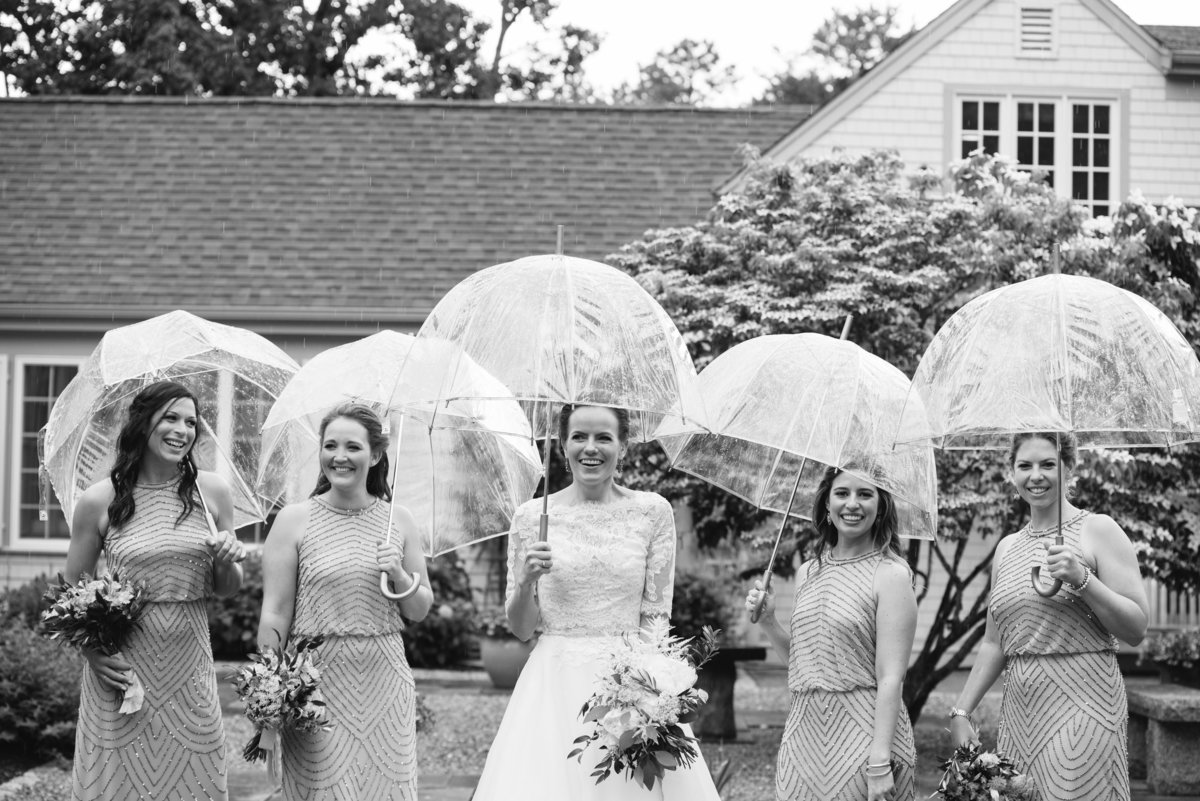 Bridesmaids in the rain with umbrellas