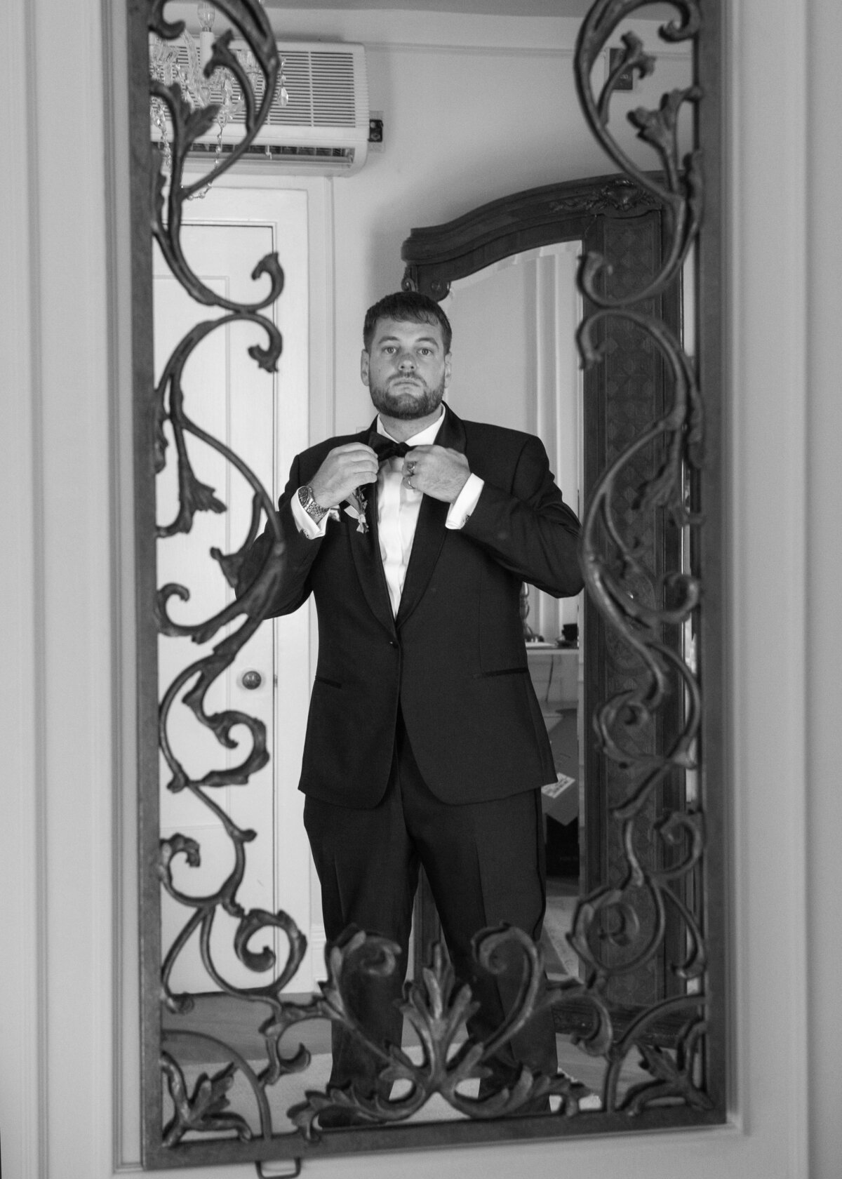 Groom looking in a mirror