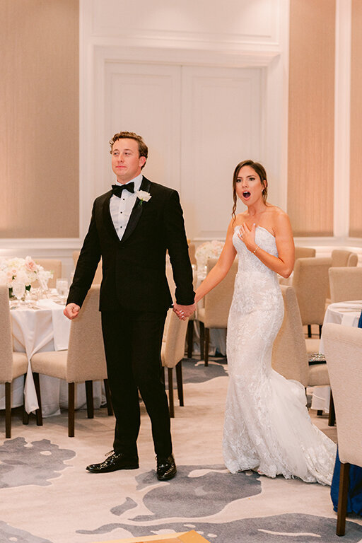 Bride and groom entering wedding reception at  at Hotel Crescent Court, Dallas