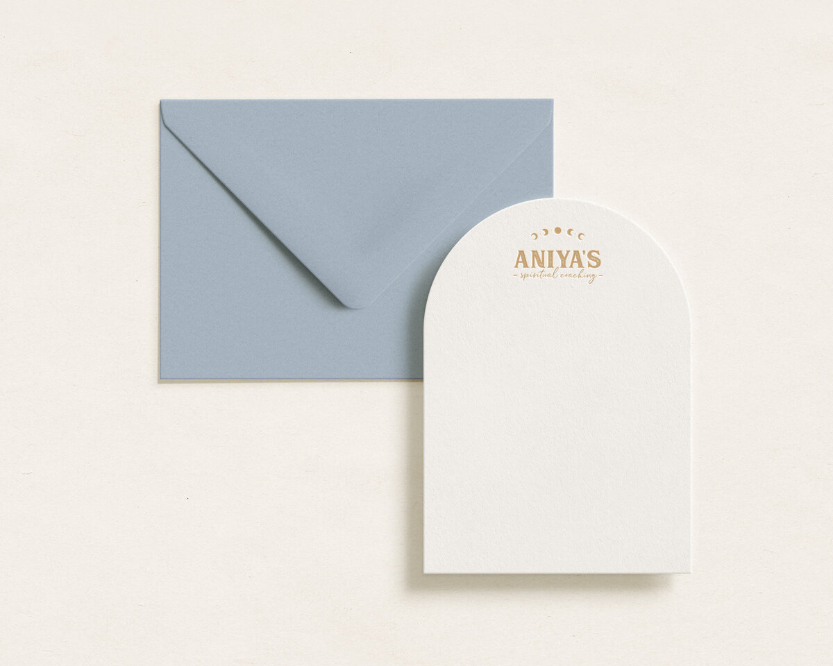 Light blue envelope next to branded note card