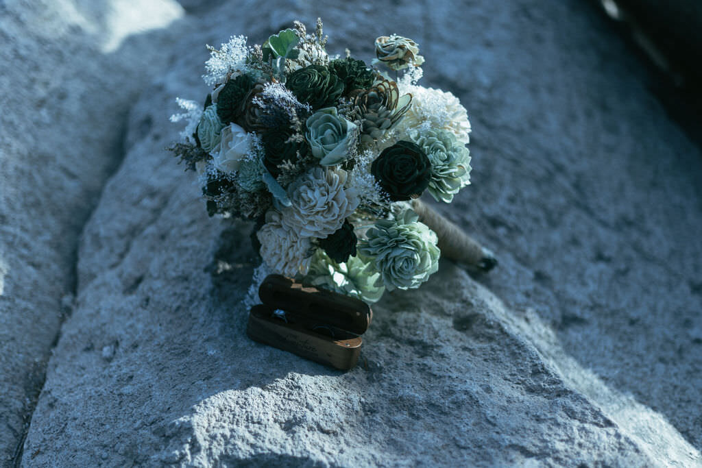 A bouquet of flowers on a rock.