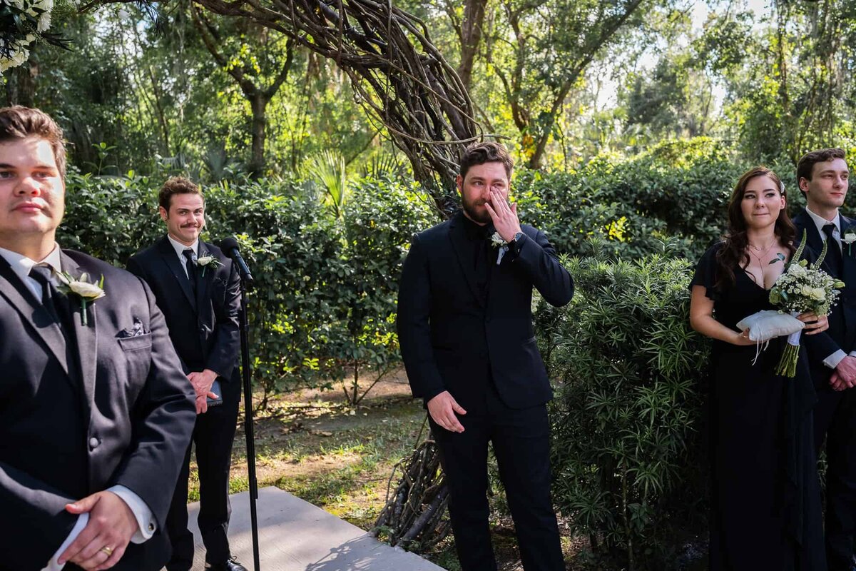 Groom getting emotional seeing his bride walk down the aisle captured by Tampa Wedding photographers at Bakers Ranch wedding Venue in Tampa Florida