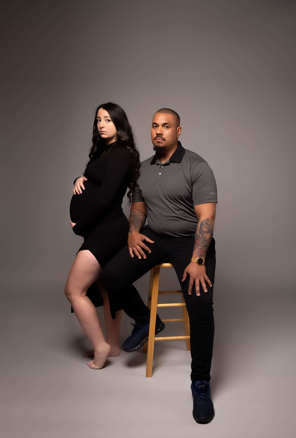 husband and wife in maternity session with reva davis photography